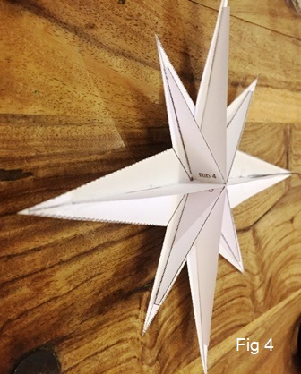 Making a Christmas card star decoration.